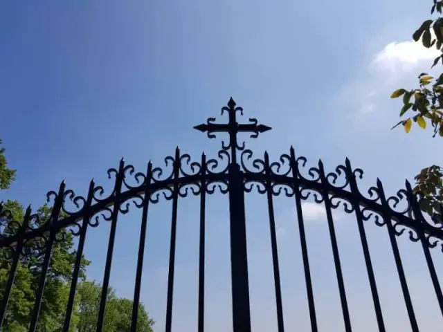 Portail en fer forgé surmonté d'une croix
